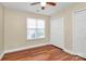 Bedroom with hardwood flooring, a ceiling fan, and a double closet at 15707 Southern Garden Ln, Charlotte, NC 28278