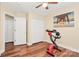 Bedroom with wood-look floors, ceiling fan, closet, and natural light at 15707 Southern Garden Ln, Charlotte, NC 28278