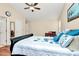 Bright bedroom with a fan, hardwood floors and a comfortable, decorated bed at 15707 Southern Garden Ln, Charlotte, NC 28278