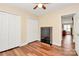 Bedroom featuring wood floors, ceiling fan, a closet and cabinet for storage at 15707 Southern Garden Ln, Charlotte, NC 28278