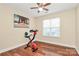 Bedroom with ceiling fan, wood-look floors, an exercise bike, and natural light at 15707 Southern Garden Ln, Charlotte, NC 28278