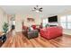 Comfortable living room with a fireplace, ceiling fan and hardwood floors at 15707 Southern Garden Ln, Charlotte, NC 28278