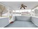 Relaxing screened porch with ceiling fan and a view of the back yard for outdoor enjoyment at 15707 Southern Garden Ln, Charlotte, NC 28278