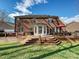 Backyard view of the brick home from the wooden deck at 15715 Holyhead Ln, Huntersville, NC 28078
