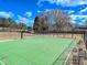 Outdoor basketball court surrounded by lush greenery and a fence, promoting an active lifestyle at 15715 Holyhead Ln, Huntersville, NC 28078