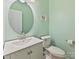 Charming powder room with a round mirror and decorative accents, adding a touch of elegance at 15715 Holyhead Ln, Huntersville, NC 28078