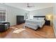 Serene main bedroom with a ceiling fan, hardwood floors, and ample natural light for relaxation at 15715 Holyhead Ln, Huntersville, NC 28078