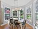 Sun-filled dining area with large windows and modern lighting fixtures overlooks the landscaped yard at 15715 Holyhead Ln, Huntersville, NC 28078