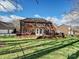 Beautiful brick home featuring a large deck, screened porch, and well-maintained lawn at 15715 Holyhead Ln, Huntersville, NC 28078