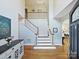 Open foyer with hardwood floors, staircase, and tall ceilings for an airy, spacious feel at 15715 Holyhead Ln, Huntersville, NC 28078