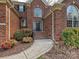 Inviting entrance featuring a winding sidewalk, black front door, and mature landscaping at 15715 Holyhead Ln, Huntersville, NC 28078