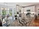 Modern kitchen with white cabinets, granite countertops, and stainless steel appliances, flowing into dining area at 15715 Holyhead Ln, Huntersville, NC 28078
