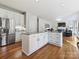 Spacious kitchen flows into the living room, featuring granite countertops and stainless steel appliances at 15715 Holyhead Ln, Huntersville, NC 28078