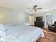 Bright main bedroom featuring hardwood floors, ceiling fan and access to ensuite bath at 15715 Holyhead Ln, Huntersville, NC 28078