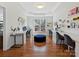 Home office with built-in desks, hardwood flooring, natural light and comfortable seating at 15715 Holyhead Ln, Huntersville, NC 28078