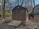 Outdoor shed with a ramp surrounded by trees and a fence, providing extra storage space at 15715 Holyhead Ln, Huntersville, NC 28078
