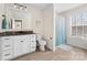 Inviting bathroom featuring a granite vanity, and a shower-tub with a stylish blue curtain at 158 Country Lake Dr, Mooresville, NC 28115