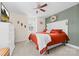 Cozy bedroom with a red comforter, decorative headboard, and natural light at 158 Country Lake Dr, Mooresville, NC 28115