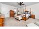 Comfortable bedroom featuring a four-poster bed, neutral carpet, ceiling fan, and double windows at 158 Country Lake Dr, Mooresville, NC 28115