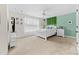 Bright bedroom featuring a queen-sized bed, natural light, and decoratively painted accent wall at 158 Country Lake Dr, Mooresville, NC 28115