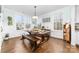 Charming dining room with a large rustic table, bench seating, wainscoting, and abundant natural light at 158 Country Lake Dr, Mooresville, NC 28115