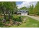 Charming two-story home with a lush front yard, mature trees, and a three-car garage at 158 Country Lake Dr, Mooresville, NC 28115