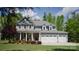 Charming two-story home featuring a manicured front lawn, attached three-car garage, and inviting front porch at 158 Country Lake Dr, Mooresville, NC 28115