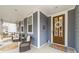 Charming front porch with cozy seating, swing, and a decorative wreath on the front door at 158 Country Lake Dr, Mooresville, NC 28115