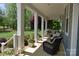Front porch boasts swing, chairs, and an inviting space to relax and unwind at 158 Country Lake Dr, Mooresville, NC 28115