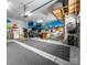 Custom garage with sports bar, multiple TVs, and ample space for parking and storage at 158 Country Lake Dr, Mooresville, NC 28115