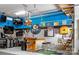 Entertaining garage featuring a custom bar, tv, painted accent wall, and hanging lights at 158 Country Lake Dr, Mooresville, NC 28115