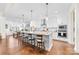 Bright, open kitchen with a granite-topped island, pendant lighting, stainless appliances, and hardwood floors at 158 Country Lake Dr, Mooresville, NC 28115