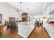 Bright open kitchen and living space with granite counters, modern appliances and stone fireplace at 158 Country Lake Dr, Mooresville, NC 28115