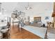 Spacious living room featuring hardwood floors, ceiling fan, high ceilings, and an open staircase at 158 Country Lake Dr, Mooresville, NC 28115