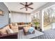 Relaxing covered outdoor patio with a ceiling fan, comfortable seating, and views of the backyard at 158 Country Lake Dr, Mooresville, NC 28115