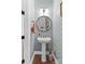 Stylish powder room with patterned wallpaper, pedestal sink, and modern fixtures at 158 Country Lake Dr, Mooresville, NC 28115