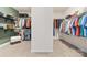 Spacious walk-in closet with ample shelving and racks for organized storage and carpet flooring at 158 Country Lake Dr, Mooresville, NC 28115