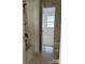 Clean bathroom showing tub/shower with a view into a carpeted bedroom through an open door at 1754 Pergola Pl, Charlotte, NC 28213