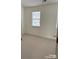 Cozy bedroom with neutral carpet, window with blinds, and fresh, light-colored walls at 1754 Pergola Pl, Charlotte, NC 28213