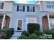 Charming townhouse showcasing a well-maintained front yard, and bright exterior at 1754 Pergola Pl, Charlotte, NC 28213