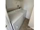 Laundry area with a white, stacked washer and dryer, and a tile floor at 1754 Pergola Pl, Charlotte, NC 28213