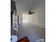 Spacious, carpeted living room features a ceiling fan and natural light through a glass door at 1754 Pergola Pl, Charlotte, NC 28213