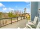 Relaxing back deck featuring rocking chairs with peaceful outdoor view at 18607 Mainsail Ct, Lancaster, SC 29720