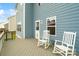 Cozy back deck featuring rocking chairs, an outdoor table and peaceful outdoor view at 18607 Mainsail Ct, Lancaster, SC 29720