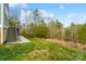 Spacious backyard featuring lush grass, a staircase and a wooded area in the distance at 18607 Mainsail Ct, Lancaster, SC 29720