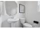 Clean and modern half-bathroom features a pedestal sink and toilet, and is finished with neutral tones at 18607 Mainsail Ct, Lancaster, SC 29720