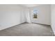 Bright bedroom features a window with a view and neutral walls at 18607 Mainsail Ct, Lancaster, SC 29720