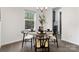 Cozy dining area with a modern light fixture and a round table set for a meal at 18607 Mainsail Ct, Lancaster, SC 29720