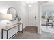 Well-lit foyer featuring a decorative mirror, console table, and hardwood flooring at 18607 Mainsail Ct, Lancaster, SC 29720