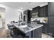 Well-equipped kitchen island with stainless steel appliances, granite countertops, and barstool seating at 18607 Mainsail Ct, Lancaster, SC 29720